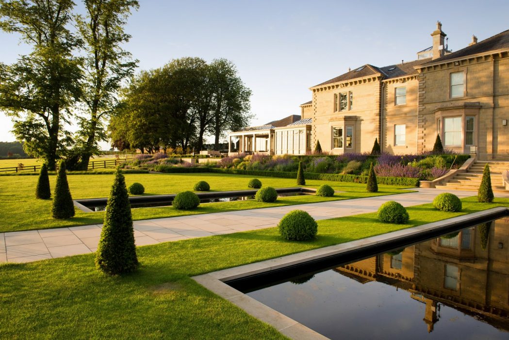 topiary pond flowing colourful welch landscape design